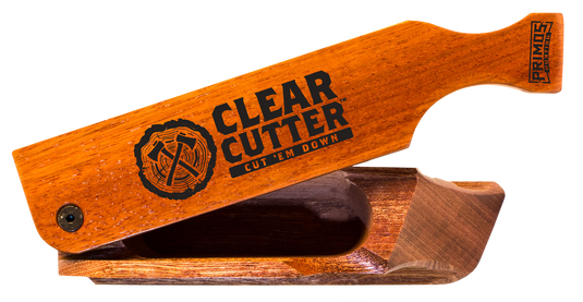 The Primos Clear Cutter™ Turkey Call features a labeled handle and an intricately carved wooden base.