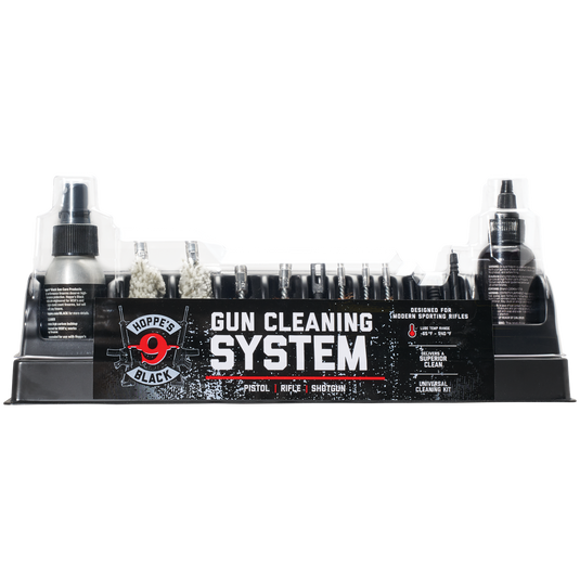 Hoppe's Black Universal gun cleaning kit with brushes, oil, and tools in a black tray with a clear cover.