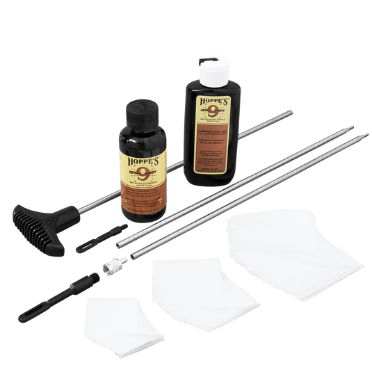 Gun cleaning kit with bottles, rods, and cloths on a white background