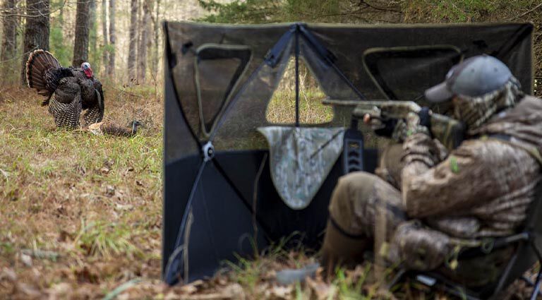 Turkey Hunter using a Stakeout Hunting Blind